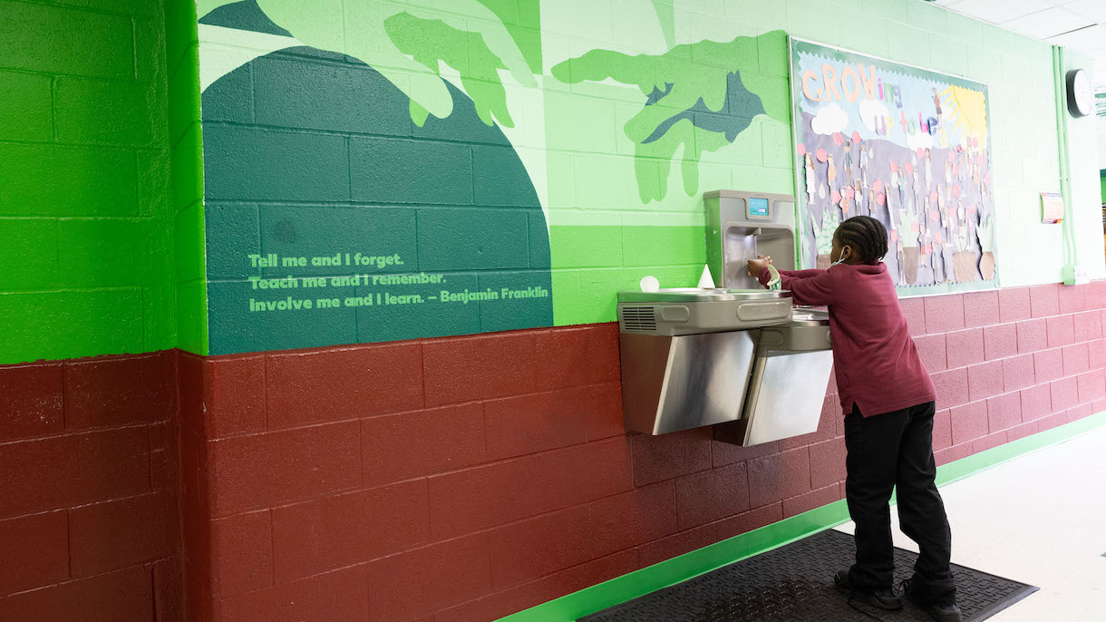 Student in the hallway at Nuasin Next Generation Charter School, partner school of the Teacher Residency program.