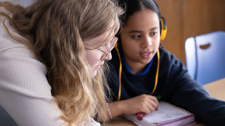 Resident teacher using her Master of Arts in Teaching degree to work with a child in a classroom